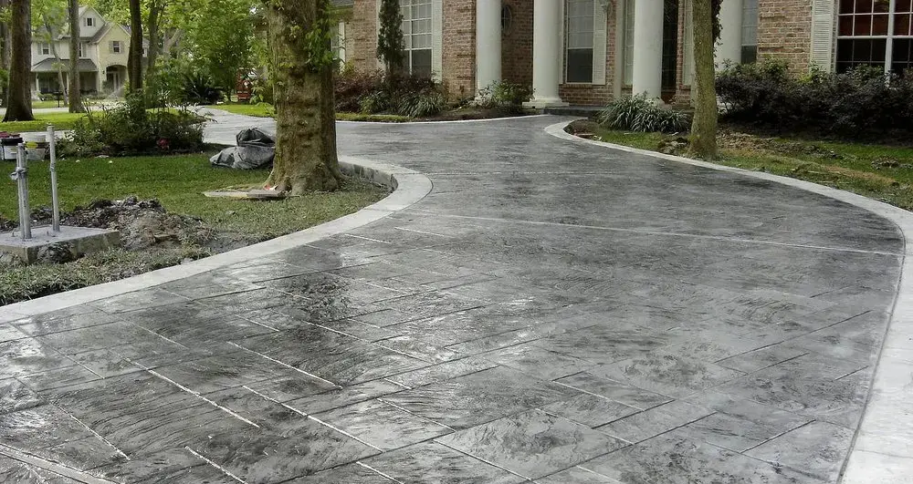 Gray ashlar-pattern stamped concrete driveway at a Lakeland home